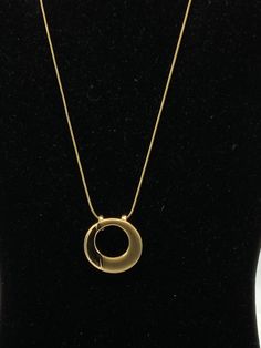 Round gold tone necklace by Lia Sophia Elegant Gold Metal Charm Necklaces, Elegant Gold Metal Charm Necklace, Modern Gold Metal Charm Necklaces, Modern Gold Pendant Chain Necklace, Modern Gold Metal Charm Necklace, Elegant Gold Chain Necklace With Large Pendant, Elegant Gold Necklace With Large Pendant, Modern Gold-tone Clavicle Chain Necklace, Elegant Gold-tone Metal Necklaces