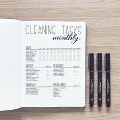 an open planner with three pens on top of it and the words cleaning tasks written in cursive writing