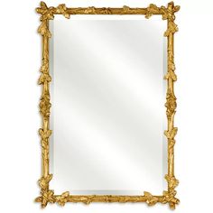 an ornate gold framed mirror on a white background, with the reflection of leaves in it