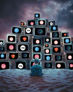 a person sitting in front of a pile of tvs with different icons on them