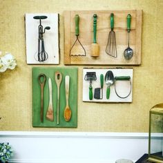 kitchen utensils are hanging on the wall