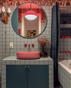 a bathroom with a sink, mirror and bathtub in the corner next to it