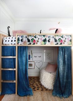 there is a bunk bed with curtains on it