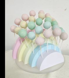 Cakepops colocados em estrutura de esferovite Cake Pops Pastel Colors, Rainbow Birthday Dessert Table, Pastel Rainbow Bridal Shower Ideas, Care Bear Cake Pops, Pastel Rainbow Cake Pops, Pastel Rainbow Birthday Theme, Rainbow Theme Gender Reveal, Pastel Rainbow Centerpieces, Pastel Rainbow Dessert Table