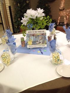 there is a table set up with flowers and candy