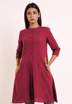 Cotton Slub A Line Pleated Kurti in Magenta. This Readymade Attire is Beautifully Highlighted with Pockets, Moulded Buttons and Resham Work, Crafted in Mandarin Collar and Quarter SleevesIts Length is 34 inches.Do Note: Bottom and Accessories shown in image is for presentation purpose only ( Slight variation in actual color vs. image is possible) We sell all kinds of women's and ladies tops Casual Kurtas |Indian Tops |Gowns |Ladies Dresses |Indian Fashionable Tops |Indian topwear |Office wear |H Pleated Kurti, Tops Indian, Pocket Design Fashion, Top Designs For Women, Plain Kurti, Girls Kurti, Design Kurta, Indian Tops, Angrakha Style