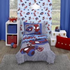 a bedroom with spiderman bedding and blue curtains