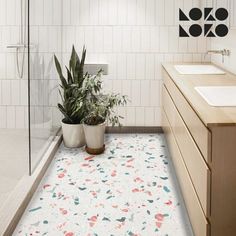 a bathroom with a plant in the middle of the floor and a sink on the other side