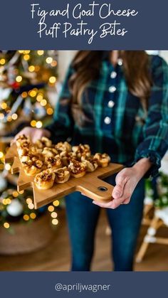 a woman holding a tray with food on it and the words fig and goat cheese puff pastry bites