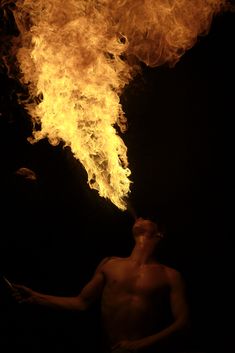 a man standing in front of a fire