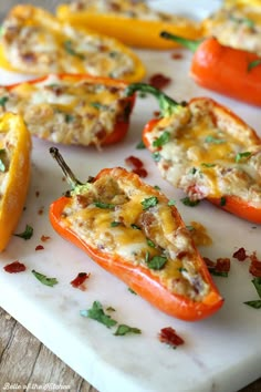 stuffed peppers with cheese and herbs on a cutting board