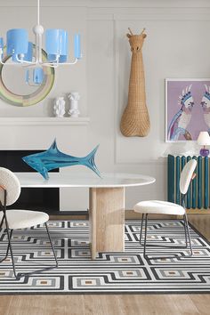 a dining room table with chairs around it and artwork on the wall in the background