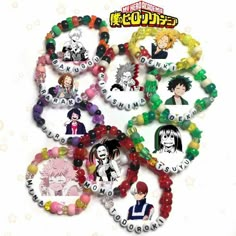 many different bracelets with anime characters on them