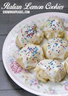 a plate filled with cookies covered in frosting and sprinkles on top of a table