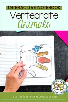 an interactive notebook with the words vertebrate animals on it and a hand holding a pen