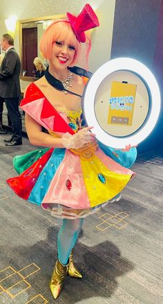 a woman dressed up as a clown holding an item