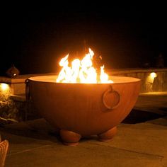 a fire pit sitting on top of a cement floor