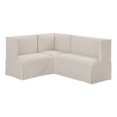 the corner sofa is covered with a white fabric material and sits on top of an off - white background