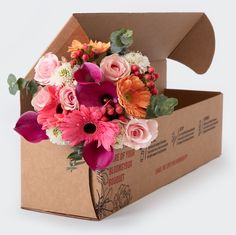 a cardboard box with flowers in it