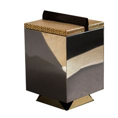 a black and gold box sitting on top of a metal stand