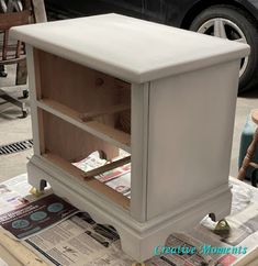 a white cabinet sitting on top of a table