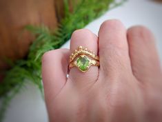 Bold but delicate, our stunning Peridot ring is uniquely handcrafted by wax and cast in Solid 14k Gold - the organic textured band adds a touch of rustic charm to this ethereal beauty. As the birthstone for August, this green crystal ring takes centre stage by creating a mesmerizing play of light. This one-of-a-kind engagement ring is not just a piece of jewelry; it's a poetic expression of individuality and everlasting commitment, making it the perfect embodiment of your unique love story.T H E Green Crystal Ring, Gold Peridot Ring, Nature Inspired Engagement Ring, Engagement Rings Affordable, Centre Stage, Unique Nature, Textured Ring, Peridot Ring, Green Crystal