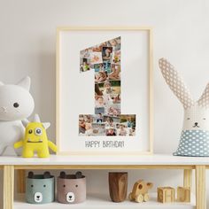 a photo frame with the number one on it next to toys and a stuffed animal