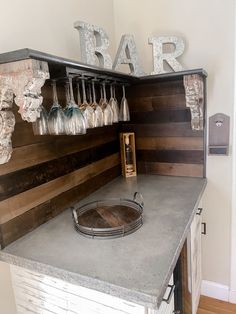 a bar with wine glasses on the counter