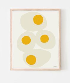 three eggs on top of each other in front of a white wall with an orange border