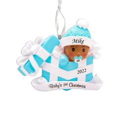 a baby's first christmas ornament with a blue and white hat