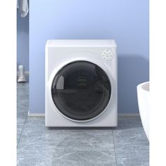 a white washer sitting on top of a tiled floor next to a blue wall