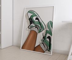 a pair of green and white tennis shoes are on display in a frame next to a bookshelf