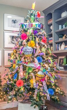 a brightly colored christmas tree decorated with ribbons