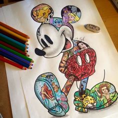 a drawing of mickey mouse on paper with colored pencils