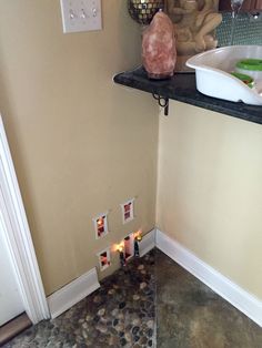 a bathroom with rocks and candles on the floor