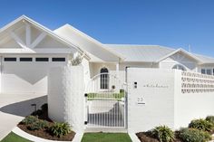 a white house with a gate in front of it