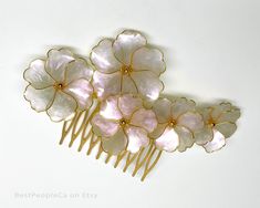 Handmade Hair Comb with large Pink-White iridescent flowers. The flowers are changing color from Pink to White while moving. Absolutely unique wedding or special occasion hair accessory.   The bouquet is about 4.5 inch length (10 cm) and 2.5 inch wide (7cm) attached to gold tone hair comb. The weight is 11 gr. The picture can't reproduce the flowers magic. This piece is graceful and exotic. Ready to ship in 2-3 days. Thank you for interest in my artwork. Alexandra. Iridescent Flowers, Patchwork Outfit, Resin Wedding, Hair Acessories, Special Occasion Hairstyles, Flower Business, Flowers Handmade, Dope Jewelry, Tone Hair