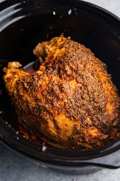 a close up of a cooked chicken in a crock pot