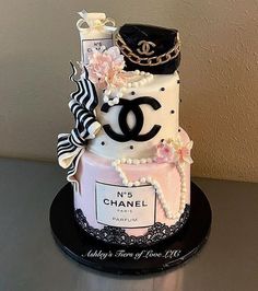 a chanel themed cake is displayed on a table