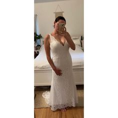 a woman in a white dress taking a selfie