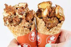 two waffle cones filled with different types of food