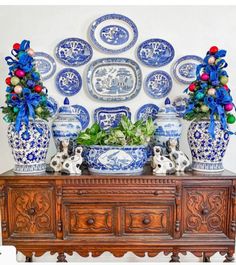 blue and white vases are on top of an old dresser