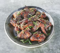 a bowl filled with cooked meat on top of a table