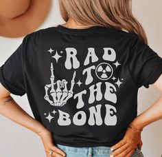 the back of a woman's shirt that says, rad to the bone