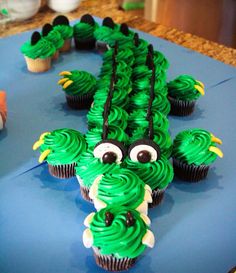 cupcakes with green frosting decorated like a dragon