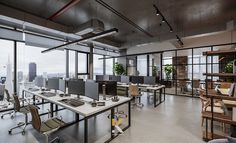 an open office with lots of desks and chairs in it's center area