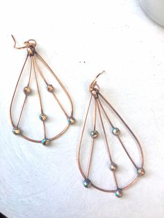 "Delicate but strong, handmade copper wire and Swarovski earrings, using 16g soft copper wire and Swarovski flatbacks. I shape the copper wire into a teardrop, solder the top joint, and add several strands of 22g wire. I place spots of solder on in the copper wire, hammer, and affix crystal flat backs to the solder and finish with a handmade earri wire. Size is approx 2.5\" long x 1.5 at the widest part. Very lightweight, sparkle beautifully when wearing. You can also remove the earring wire, tu Copper Wire Teardrop Earrings, Copper Teardrop Hoop Earrings With Ear Wire, Teardrop Wire Wrapped Earrings, Bronze Metal Teardrop Earrings, Bohemian Copper Wire Wrapped Teardrop Earrings, Bronze Teardrop Copper Earrings, Bronze Copper Teardrop Earrings, Handmade Copper Teardrop Hoop Earrings, Teardrop Copper Hoop Earrings For Pierced Ears