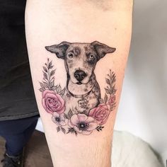 a dog with flowers around it's neck is shown on the leg, and has an image of a dog surrounded by roses