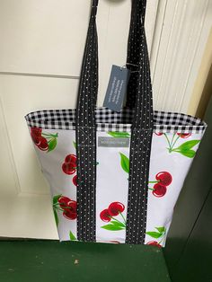 "9x11x5\" will bring back the good old days in a decidedly modern way! The outside is an endearing retro print of cherries on white . Inside is a black gingham to set off the shading in the cherries. It has a red polka dot pocket---which is great to keep car keys, cell phone or wallet within easy reach. Long padded cotton handles are black with random white dots. You can wear them over the shoulder. The bag is waterproof and will never mildew. Bring it to the grocery store, farmer's market, libr White Cotton Bag For Picnic, White Cotton Picnic Bag, White Cotton Picnic Bags, Kids Totes, Navy Gingham, Sac Lunch, Diy Purse, Halloween Animals, Red Polka Dot