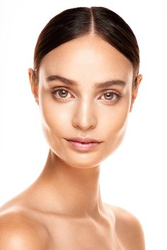 a beautiful woman with makeup on her face posing for the camera in front of a white background